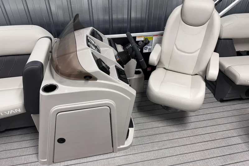 Slide: The Image of 2026 Sylvan Mirage 8520 LZ boat interior with captain's chair and control console. - 6