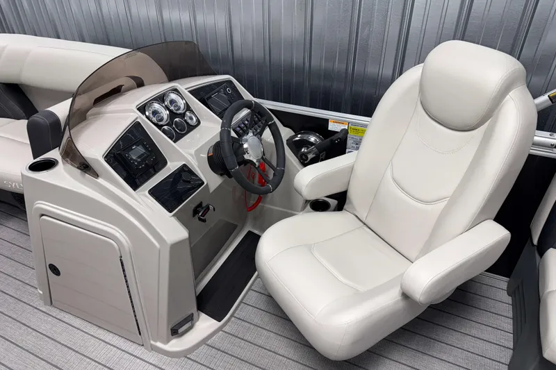 Slide: The Image of 2026 Sylvan Mirage 8520 LZ boat helm with modern controls and comfortable captain's chair. - 7