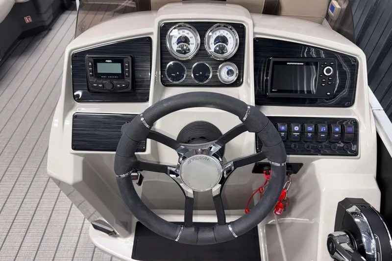 Slide: The Image of 2026 Sylvan Mirage 8520 LZ boat dashboard with steering wheel and control panel. - 9