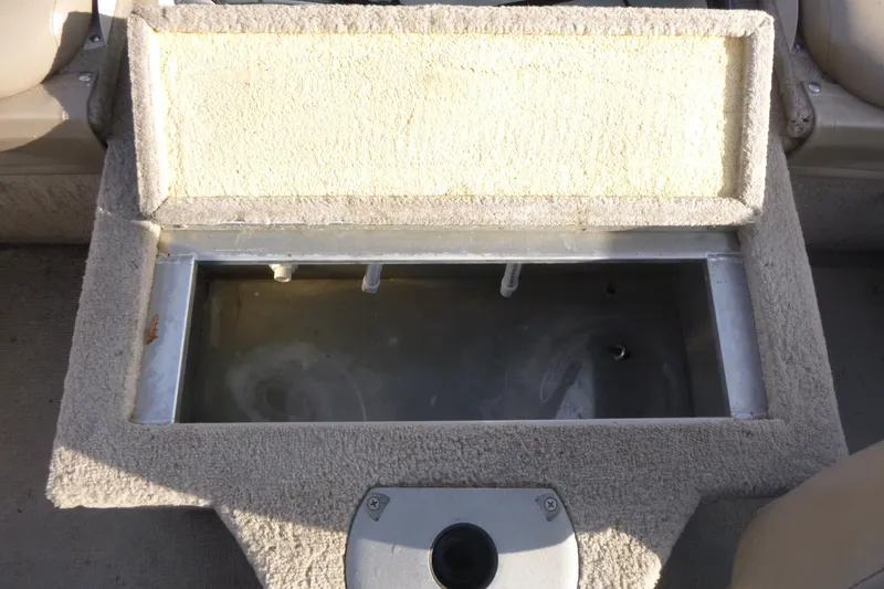 Slide: The Image of 2012 Smoker Craft Ultima 172 boat storage compartment with open lid, showing interior space. - 10