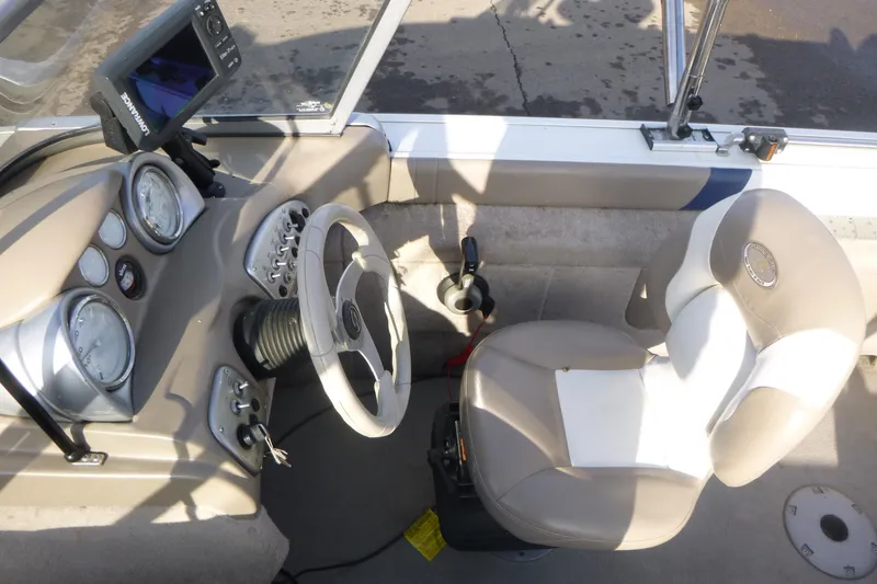 Slide: The Image of 2012 Smoker Craft Ultima 172 boat cockpit with steering wheel and control panel. - 11