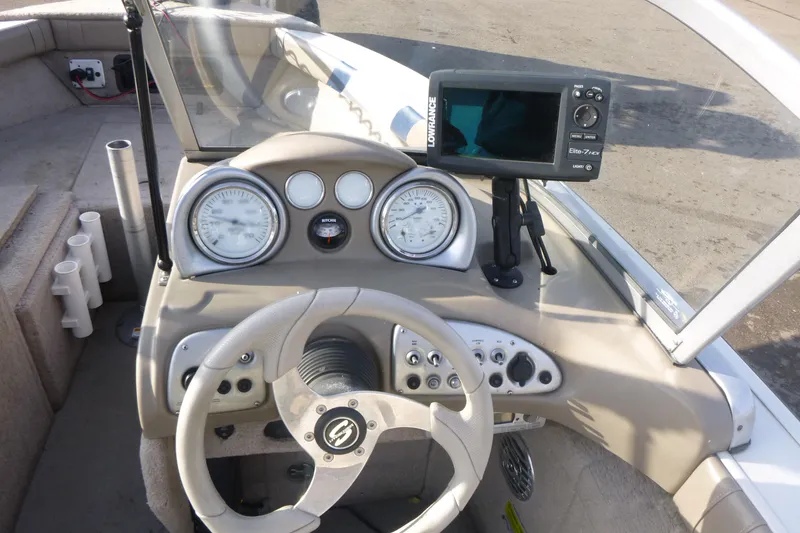Slide: The Image of 2012 Smoker Craft Ultima 172 boat dashboard with steering wheel and navigation system. - 13