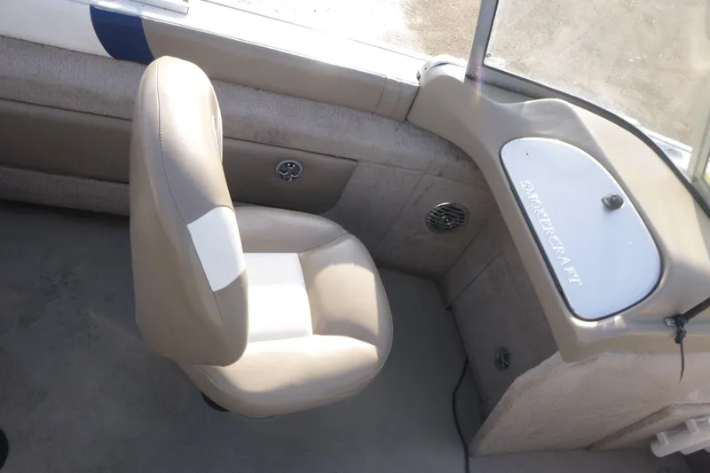 Slide: The Image of 2012 Smoker Craft Ultima 172 boat interior with beige seating and dashboard. - 14