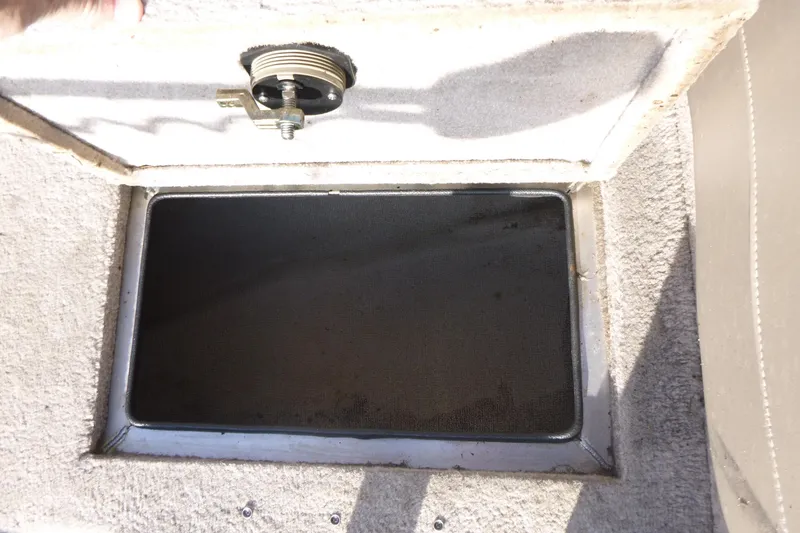 Slide: The Image of Open storage compartment in 2012 Smoker Craft Ultima 172 boat. - 17
