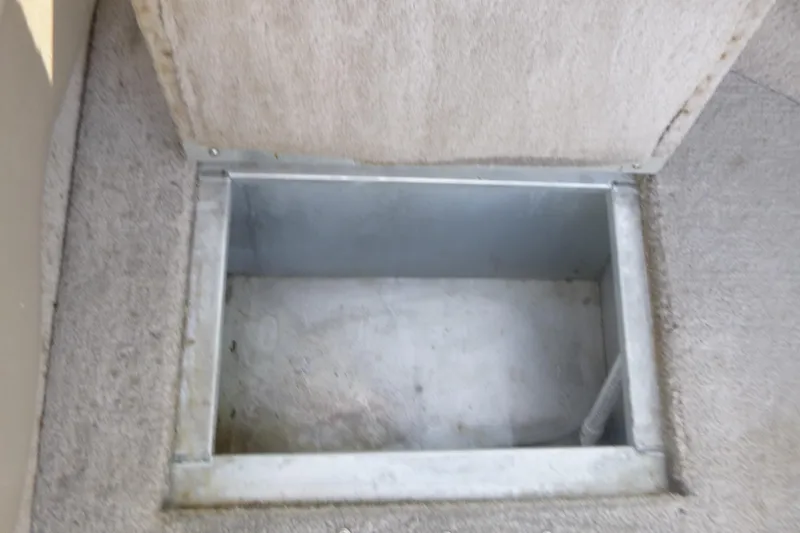 Slide: The Image of Storage compartment in 2012 Smoker Craft Ultima 172 boat, featuring metal interior. - 19