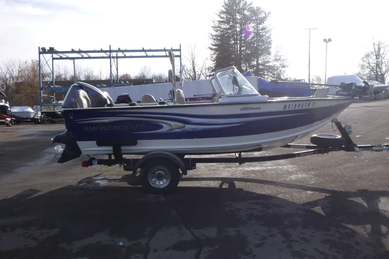 Slide: The Image of 2012 Smoker Craft Ultima 172 boat on trailer, parked outdoors. - 4