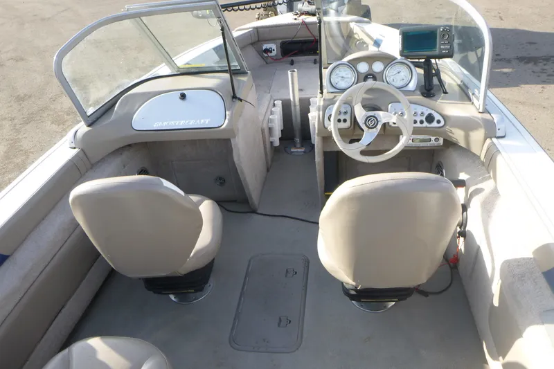 Slide: The Image of 2012 Smoker Craft Ultima 172 boat interior with steering wheel and dashboard controls. - 7