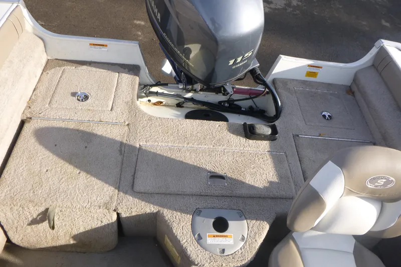 Slide: The Image of 2012 Smoker Craft Ultima 172 boat interior with Yamaha 115 engine, beige seating, and carpeted deck. - 9