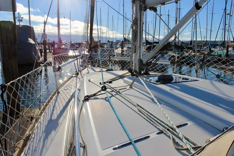 Slide: The Image of 2015 Jeanneau Sun Odyssey 349 sailboat docked in a sunny marina. - 10