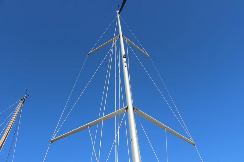 Slide: The Image of Mast of 2015 Jeanneau Sun Odyssey 349 sailboat against clear blue sky. - 15