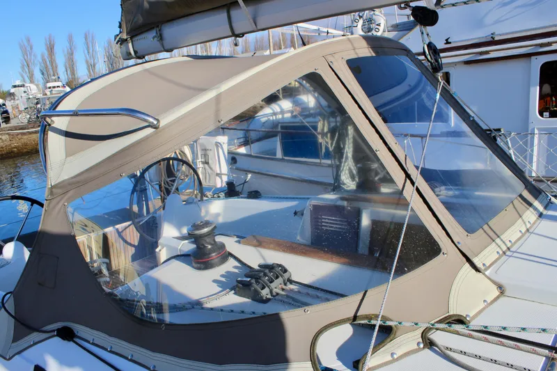 Slide: The Image of 2015 Jeanneau Sun Odyssey 349 sailboat cockpit with protective canopy and steering wheel. - 17