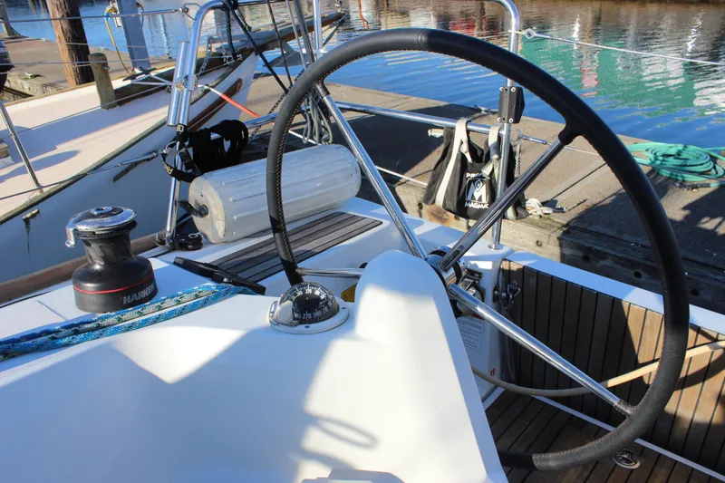 Slide: The Image of 2015 Jeanneau Sun Odyssey 349 cockpit with steering wheel and nautical equipment. - 21