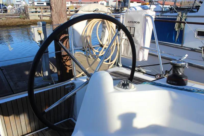 Slide: The Image of 2015 Jeanneau Sun Odyssey 349 sailboat cockpit with steering wheel and winch. - 22