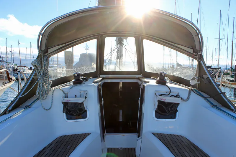 Slide: The Image of Cockpit view of 2015 Jeanneau Sun Odyssey 349 sailboat in marina at sunrise. - 25