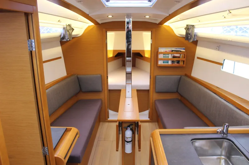 Slide: The Image of Interior of 2015 Jeanneau Sun Odyssey 349 sailboat, featuring cozy seating and modern amenities. - 29