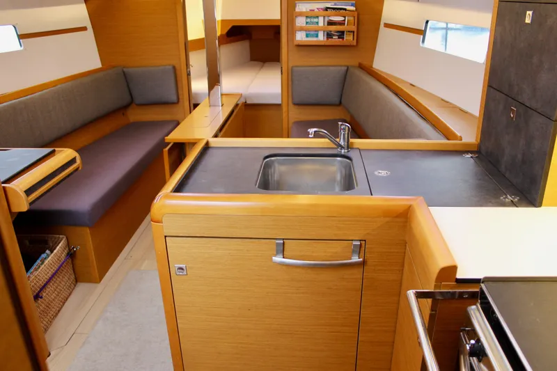 Slide: The Image of Interior of 2015 Jeanneau Sun Odyssey 349 sailboat, featuring a modern kitchen and seating area. - 30