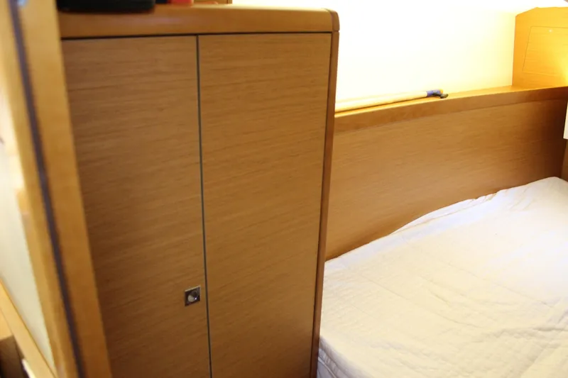 Slide: The Image of Interior cabin of 2015 Jeanneau Sun Odyssey 349 sailboat with wooden cabinetry and bed. - 37