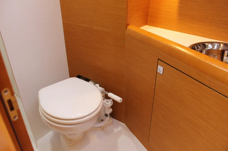 Slide: The Image of Compact bathroom in 2015 Jeanneau Sun Odyssey 349 yacht with wooden cabinetry. - 42