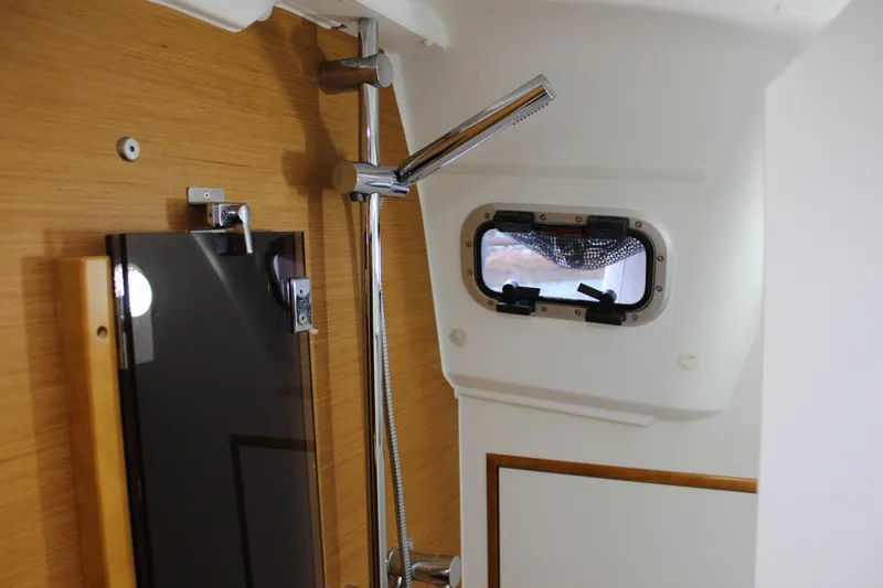Slide: The Image of Interior of 2015 Jeanneau Sun Odyssey 349 yacht, featuring a shower and porthole window. - 44
