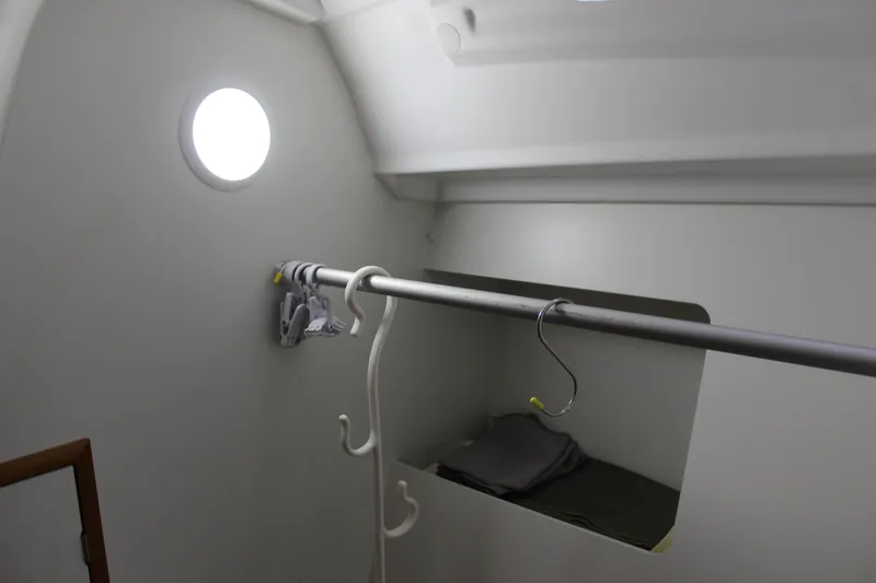 Slide: The Image of Interior of 2015 Jeanneau Sun Odyssey 349 sailboat, featuring a storage area with hangers. - 46