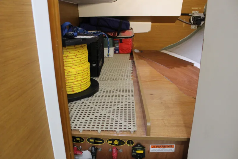 Slide: The Image of Storage area in a 2015 Jeanneau Sun Odyssey 349 sailboat with yellow rope and equipment. - 47