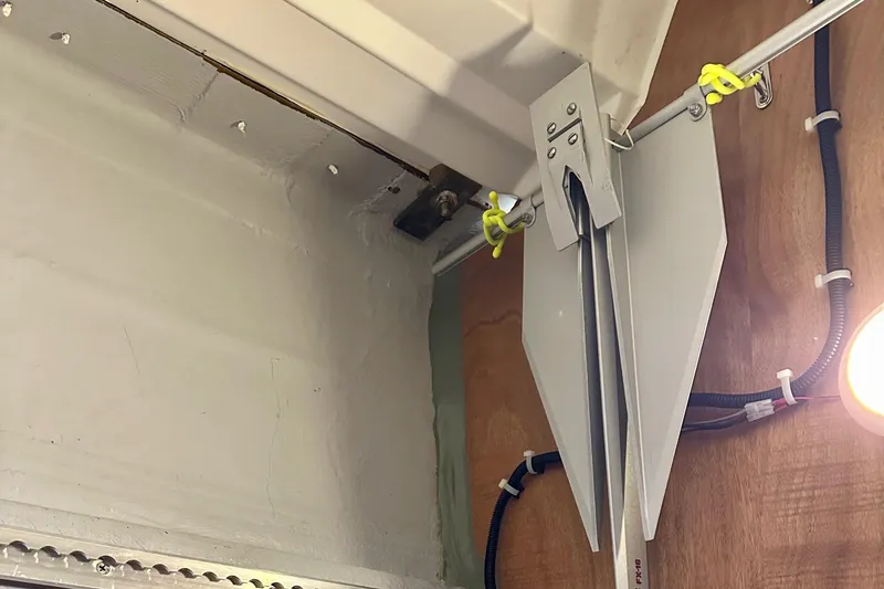 Slide: The Image of Interior view of a 2015 Jeanneau Sun Odyssey 349 sailboat, showing structural details and wiring. - 52