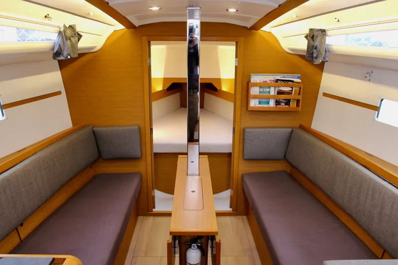 Slide: The Image of Interior of 2015 Jeanneau Sun Odyssey 349 sailboat, featuring cozy seating and wooden finishes. - 54