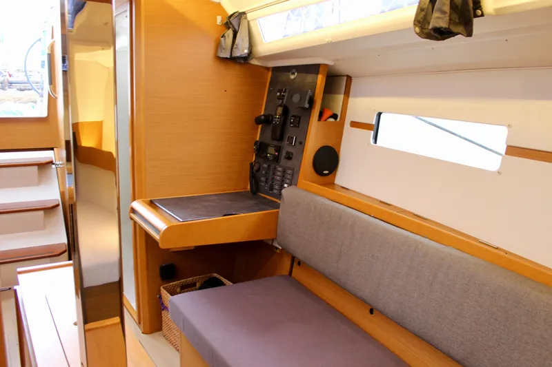 Slide: The Image of Interior of 2015 Jeanneau Sun Odyssey 349 sailboat with navigation station and seating area. - 56