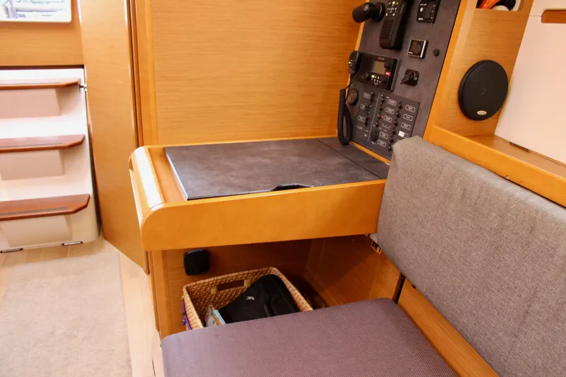 Slide: The Image of Interior of 2015 Jeanneau Sun Odyssey 349 yacht, featuring navigation station and seating area. - 57