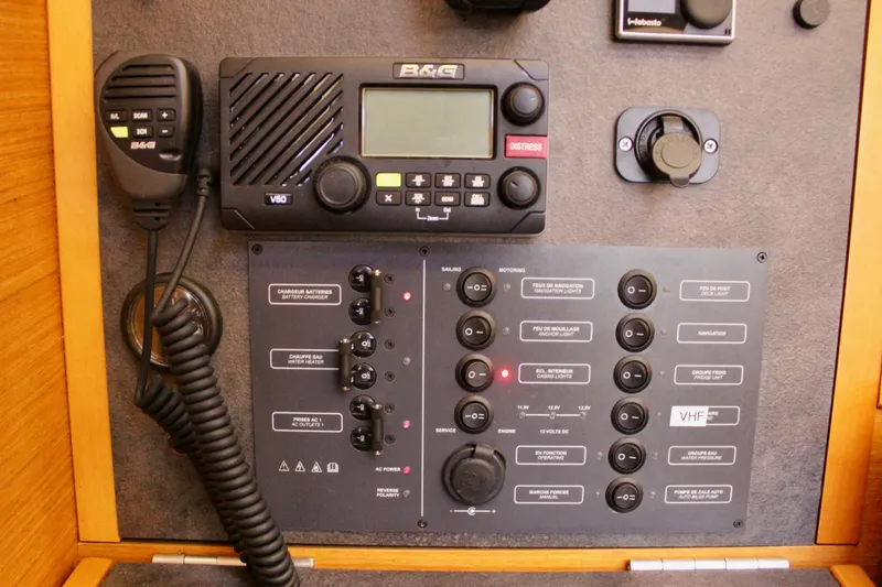 Slide: The Image of Control panel of a 2015 Jeanneau Sun Odyssey 349 sailboat with VHF radio and switches. - 58