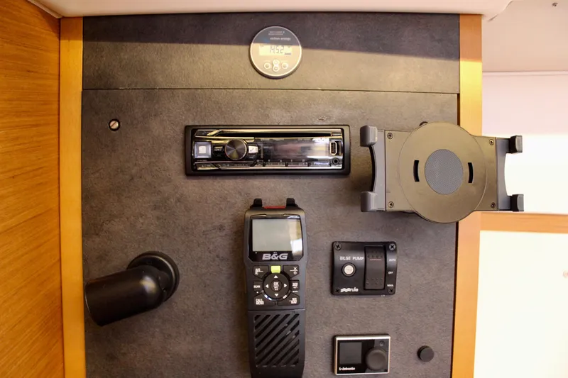 Slide: The Image of Control panel of 2015 Jeanneau Sun Odyssey 349 yacht with navigation and communication equipment. - 59