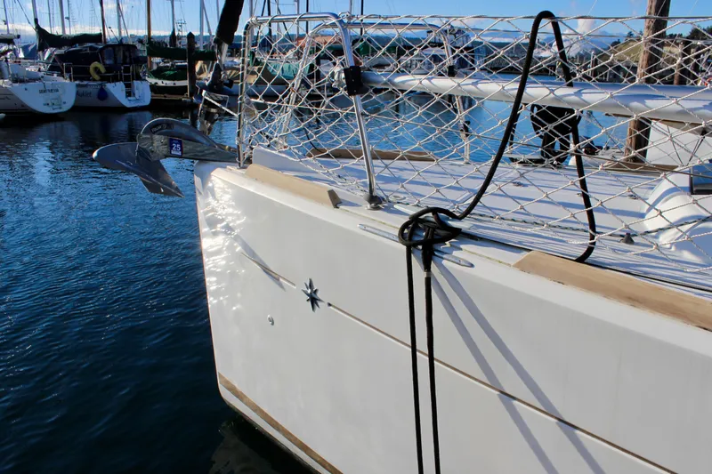 Slide: The Image of Jeanneau Sun Odyssey 349 sailboat docked in marina, 2015 model, with anchor and safety netting. - 6