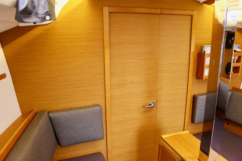 Slide: The Image of Interior of 2015 Jeanneau Sun Odyssey 349 sailboat with wooden finish and gray cushions. - 61