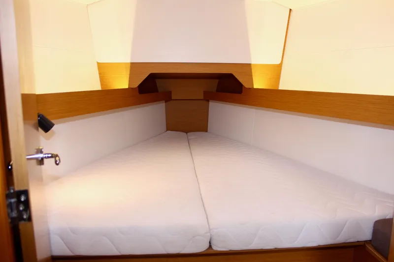 Slide: The Image of Cabin interior of 2015 Jeanneau Sun Odyssey 349 sailboat with cozy bedding. - 62