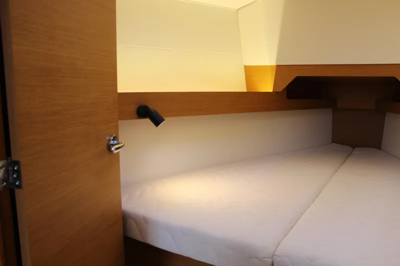 Slide: The Image of Cozy cabin interior of 2015 Jeanneau Sun Odyssey 349 sailboat, featuring a comfortable bed. - 63