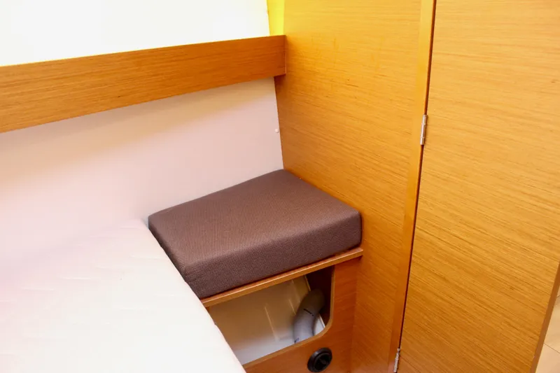 Slide: The Image of Interior of 2015 Jeanneau Sun Odyssey 349, featuring wooden cabinetry and cushioned seating. - 65