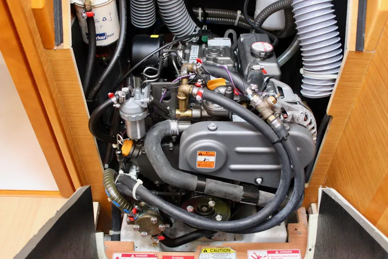 Slide: The Image of Engine compartment of 2015 Jeanneau Sun Odyssey 349 sailboat, showcasing detailed mechanical components. - 70