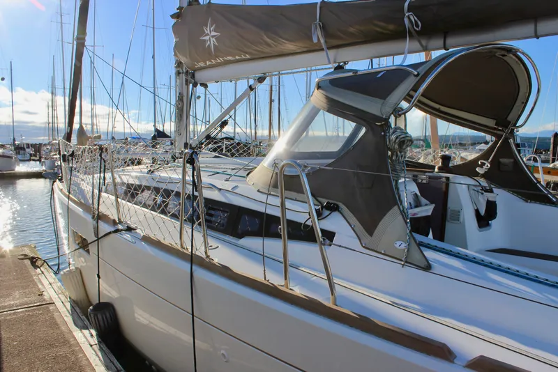 Slide: The Image of 2015 Jeanneau Sun Odyssey 349 sailboat docked in a sunny marina. - 8