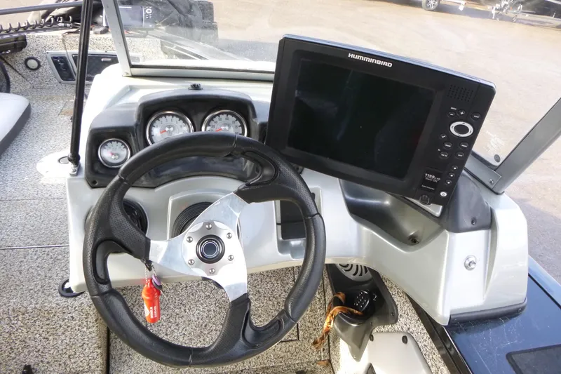 Slide: The Image of 2016 Tracker Targa V-18 WT boat dashboard with steering wheel and Humminbird fishfinder. - 12