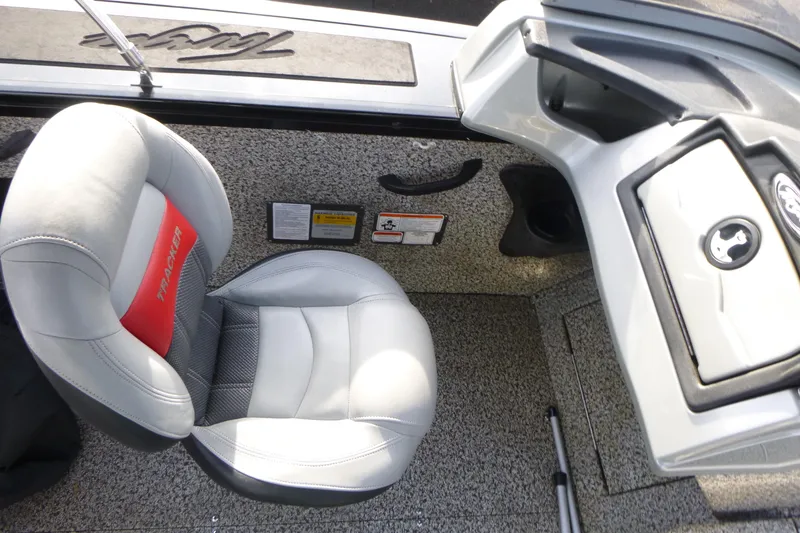 Slide: The Image of 2016 Tracker Targa V-18 WT boat interior with cushioned seat and control panel. - 13
