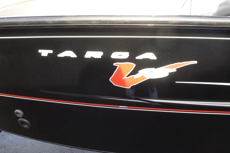 Slide: The Image of 2016 Tracker Targa V-18 WT boat logo on black surface with red accents. - 4