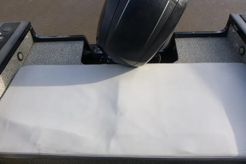 Slide: The Image of 2016 Tracker Targa V-18 WT boat interior with motor and seating area. - 7