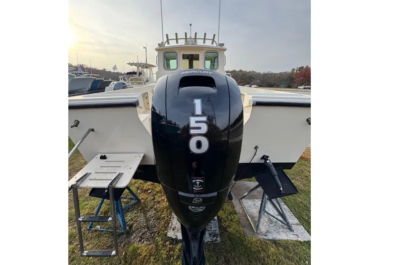 Slide: The Image of 2004 Parker 2120 Sport Cabin boat with a Mercury 150 outboard motor. - 3