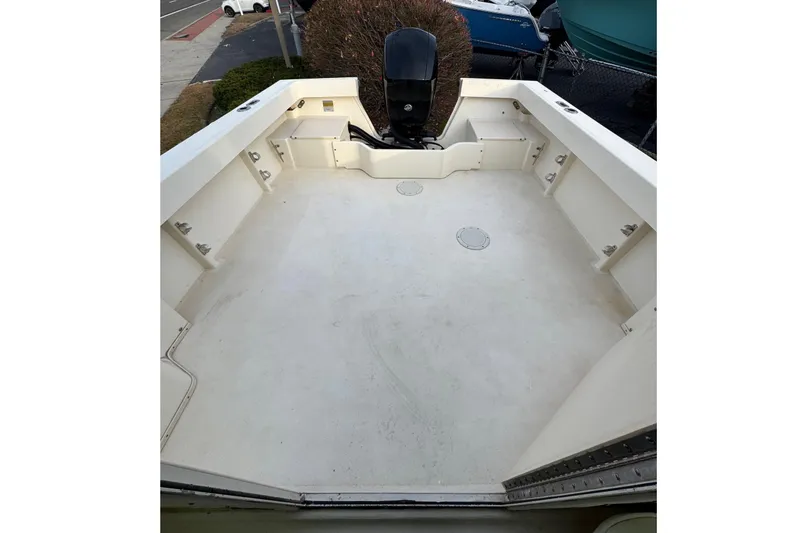 Slide: The Image of 2004 Parker 2120 Sport Cabin boat deck with outboard motor, spacious and clean. - 4