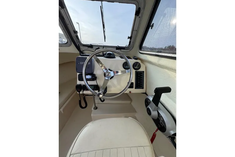 Slide: The Image of 2004 Parker 2120 Sport Cabin interior with steering wheel and control panel. - 6