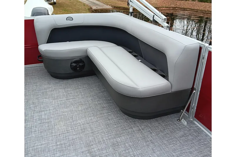 Slide: The Image of 2026 Sun Tracker Party Barge 16 DLX interior seating with gray upholstery and cup holders. - 14
