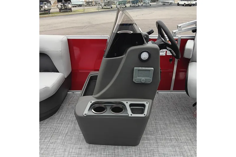 Slide: The Image of 2026 Sun Tracker Party Barge 16 DLX helm with steering wheel and cup holders. - 18