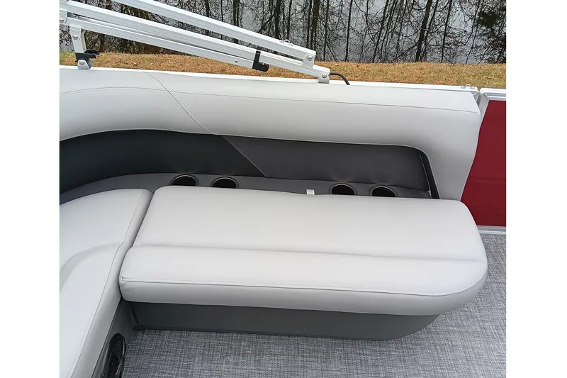 Slide: The Image of 2026 Sun Tracker Party Barge 16 DLX interior seating with cup holders, gray upholstery. - 21