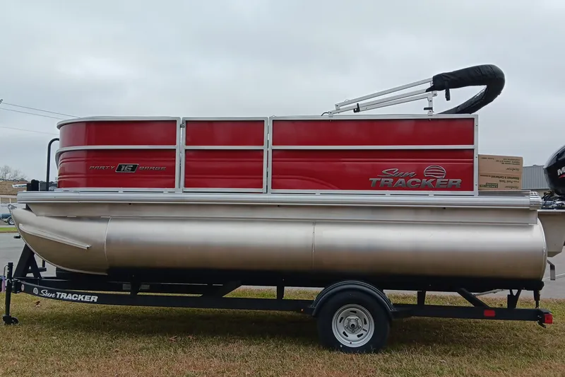 Slide: The Image of 2026 Sun Tracker Party Barge 16 DLX pontoon boat on trailer, side view. - 6