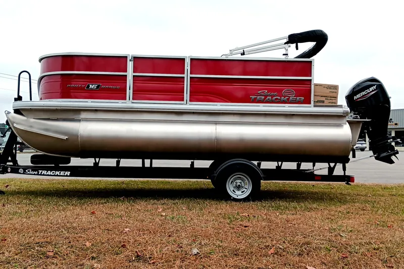 Slide: The Image of 2026 Sun Tracker Party Barge 16 DLX pontoon boat on trailer, side view. - 7